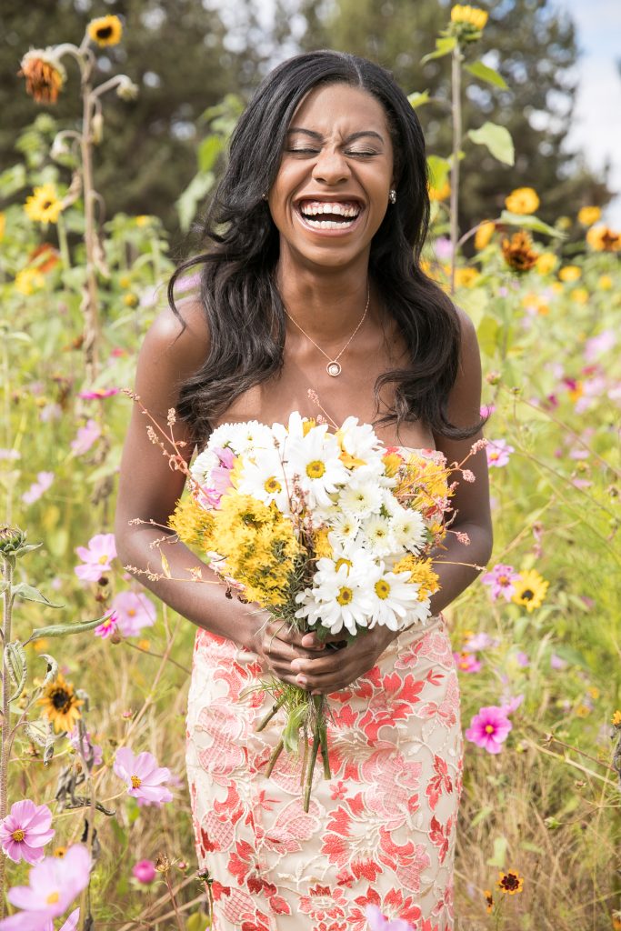 black bride laughing in wildflowers