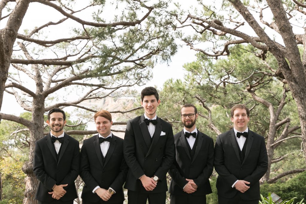 close up of groomsmen trees in background