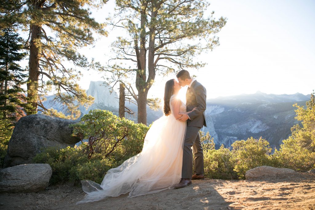 kiss at sunrise in Yosemite with sunshine